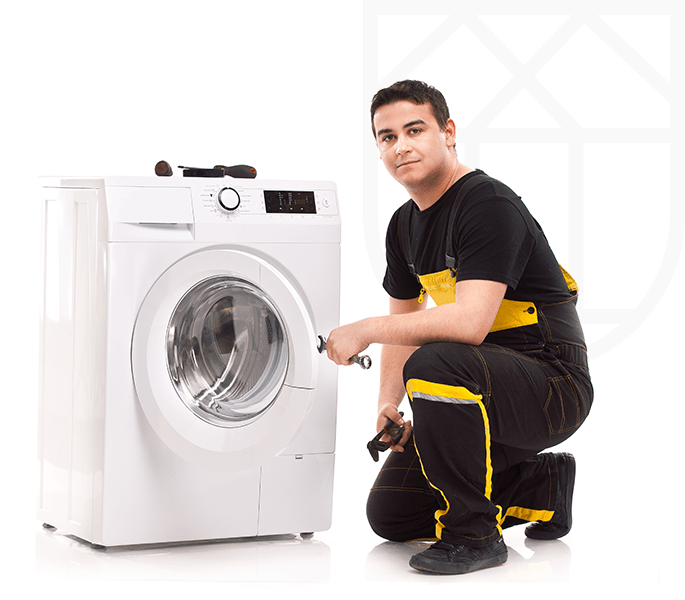 Image of male service technician repairing washing machine that was insured with a home Appliance Plan.