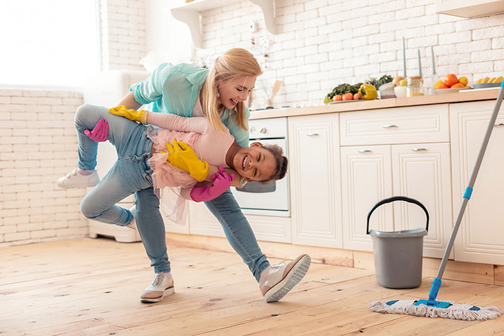 Picture of a mother and daughter playing in kitchen.